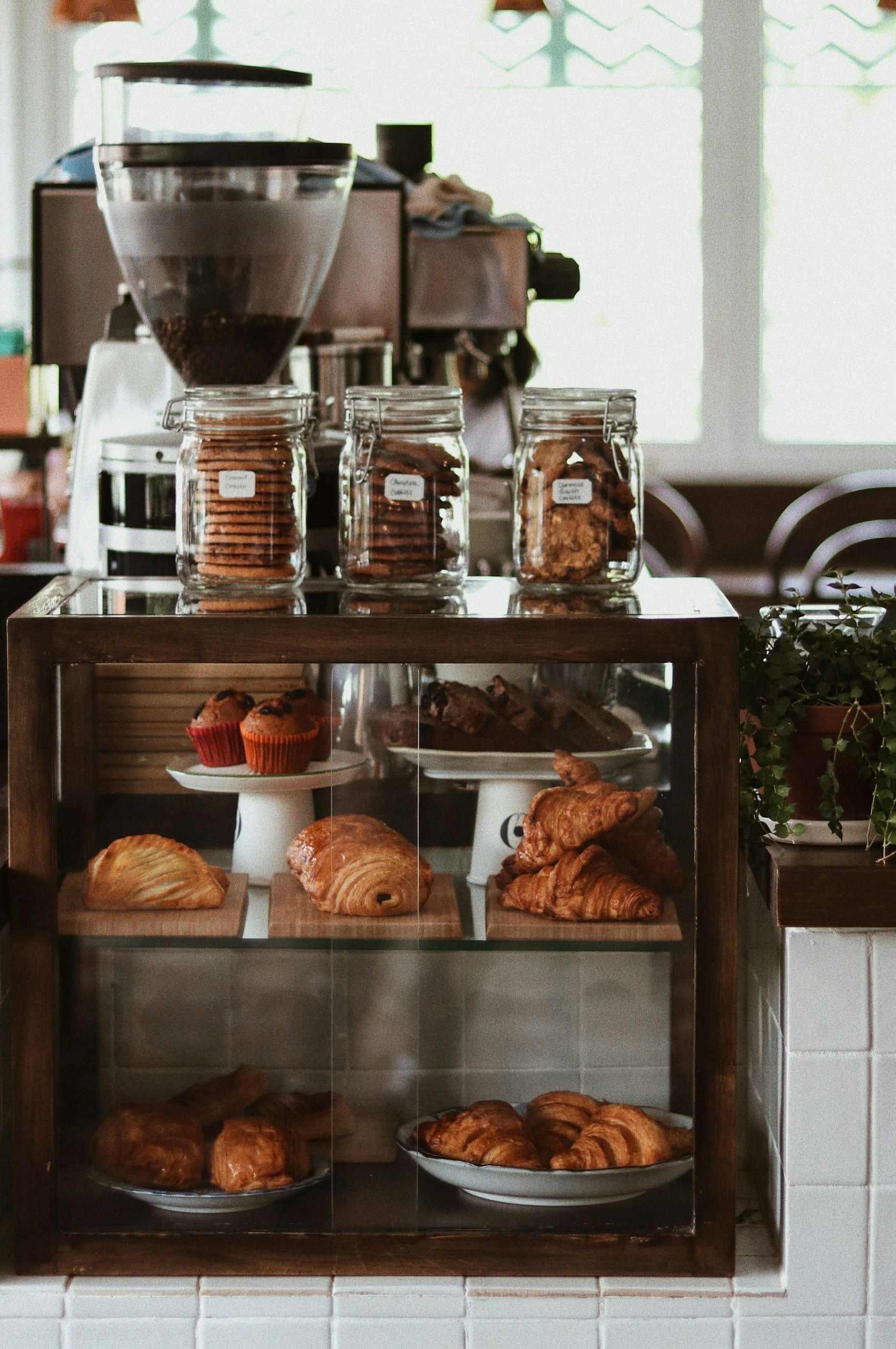 a bakery counter with pastries and coffee machines