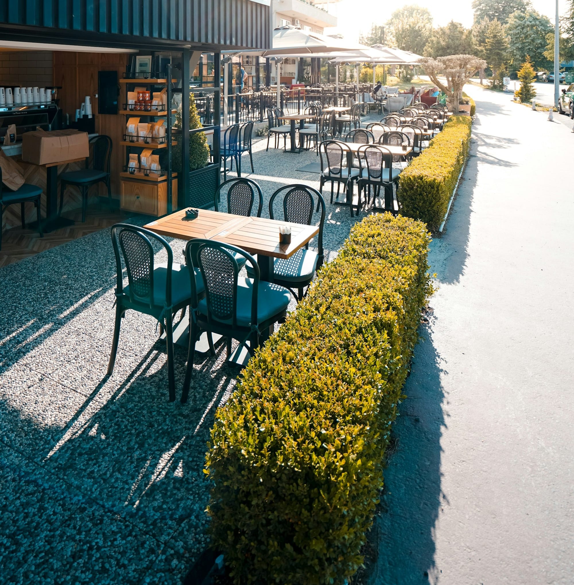 the outside of a restaurant with tables and chairs